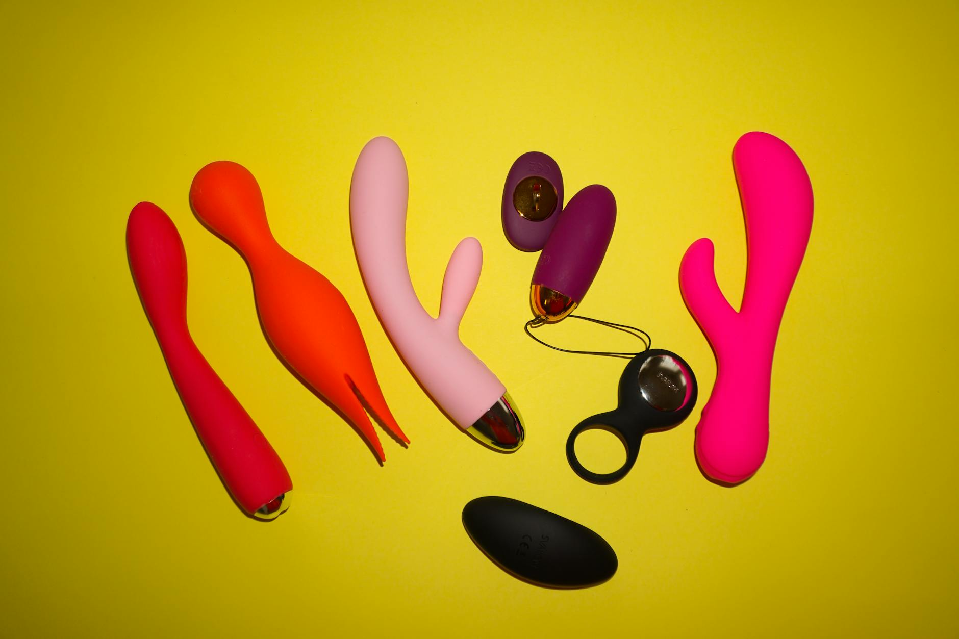 A blue silicone vibrator held in hand against a purple background, symbolizing self-love and reclaiming pleasure